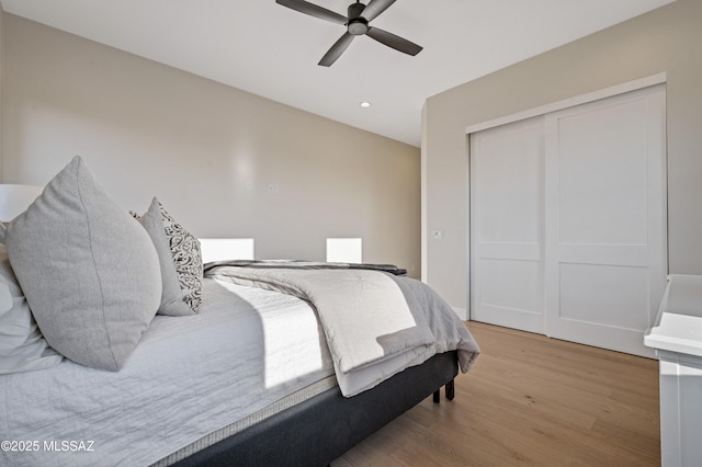 bedroom featuring light wood-style floors, a closet, recessed lighting, and a ceiling fan