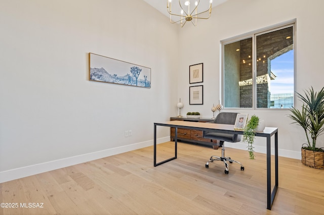 office space featuring wood finished floors, baseboards, and a chandelier