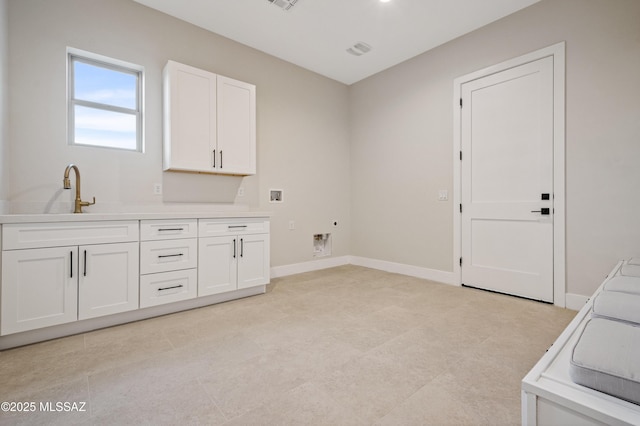 washroom with cabinet space, baseboards, and light tile patterned floors