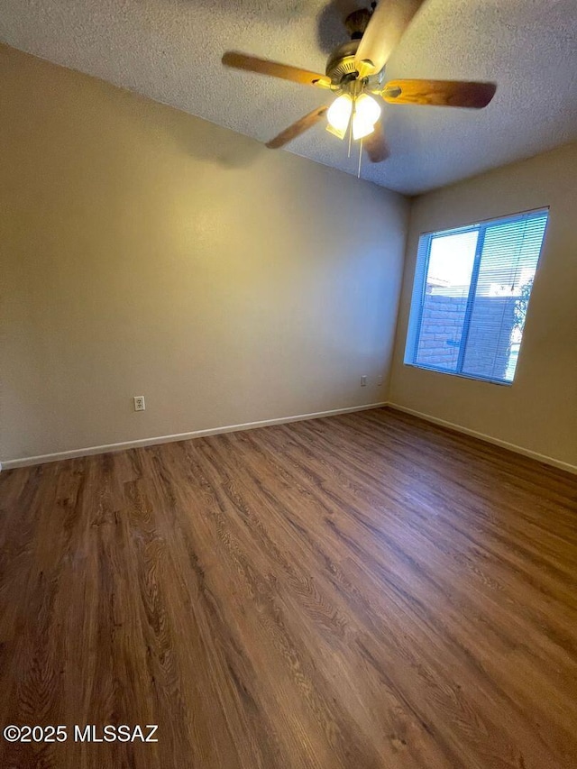 3873 N Pasatiempo Pl, Tucson, AZ 85705 - unfurnished room featuring a textured ceiling, ceiling fan, dark wood-style flooring, and baseboards