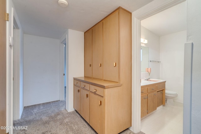 5301 E 4th St, Tucson, AZ 85711 - hallway with light colored carpet and a sink
