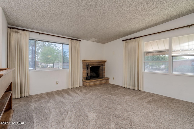 5301 E 4th St, Tucson, AZ 85711 - unfurnished living room featuring a fireplace, carpet floors, a textured ceiling, and lofted ceiling