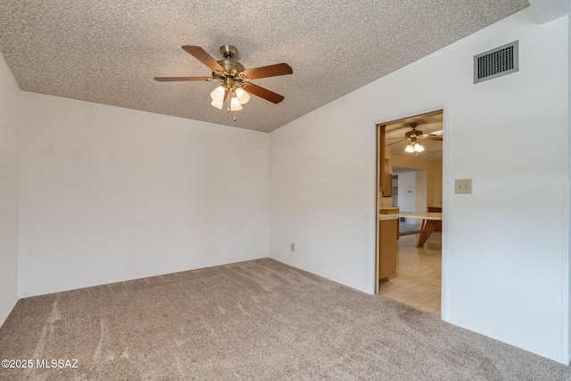 5301 E 4th St, Tucson, AZ 85711 - empty room with light colored carpet, ceiling fan, and a textured ceiling