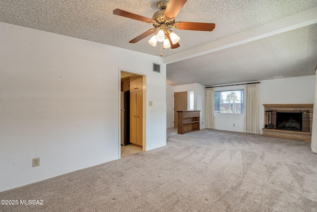 5301 E 4th St, Tucson, AZ 85711 - unfurnished living room with light carpet, a ceiling fan, a brick fireplace, and a textured ceiling
