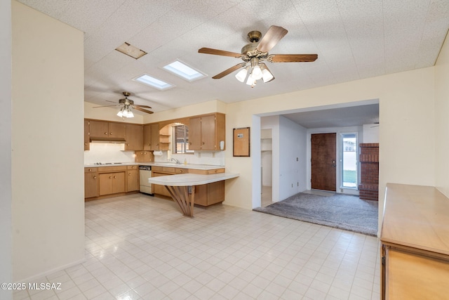 5301 E 4th St, Tucson, AZ 85711 - kitchen with a ceiling fan, light countertops, a sink, dishwashing machine, and a peninsula