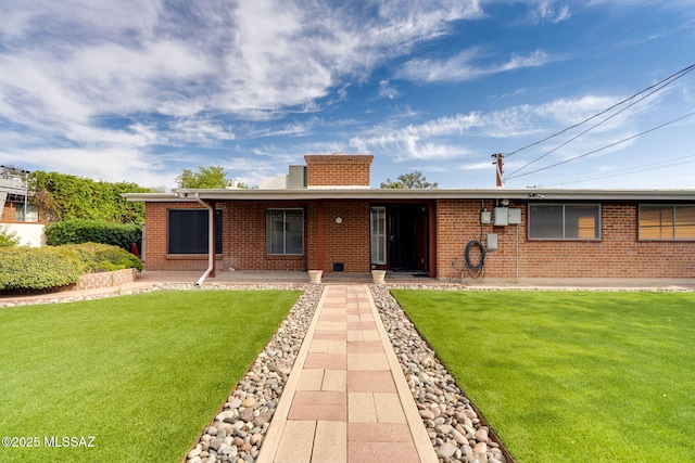5301 E 4th St, Tucson, AZ 85711 - ranch-style house with brick siding, a chimney, and a front lawn