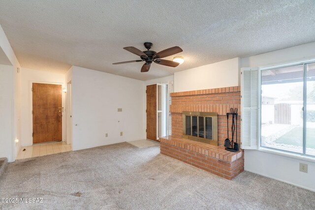 5301 E 4th St, Tucson, AZ 85711 - unfurnished living room with carpet, a ceiling fan, a brick fireplace, and a textured ceiling