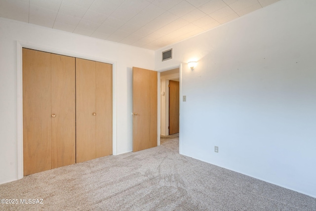 5301 E 4th St, Tucson, AZ 85711 - unfurnished bedroom featuring carpet and a closet