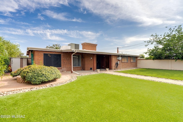 5301 E 4th St, Tucson, AZ 85711 - rear view of house featuring brick siding, a patio, and a chimney