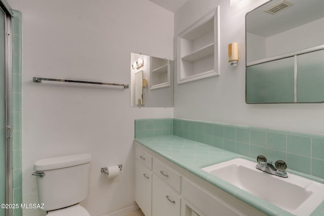 5301 E 4th St, Tucson, AZ 85711 - bathroom with vanity, toilet, and an enclosed shower