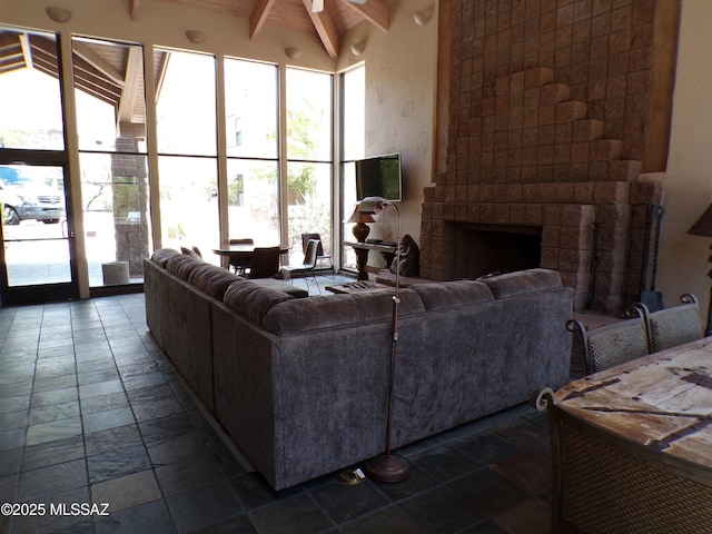 6655 N Canyon Crest Dr Unit 19201, Tucson, AZ 85750 - living room with stone tile flooring, a fireplace, and ceiling fan