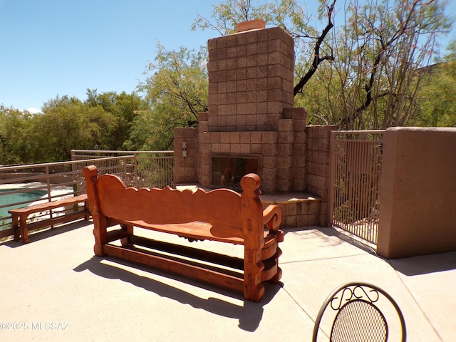 6655 N Canyon Crest Dr Unit 19201, Tucson, AZ 85750 - view of patio / terrace featuring exterior fireplace