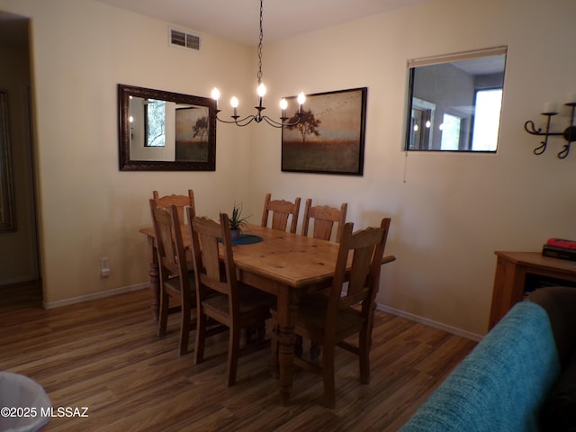 6655 N Canyon Crest Dr Unit 19201, Tucson, AZ 85750 - dining space featuring a chandelier, wood finished floors, and baseboards