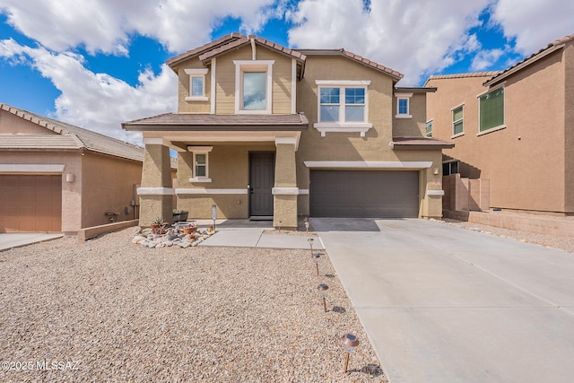 10487 S Cutting Horse Dr, Vail, AZ 85641 - view of front facade with an attached garage, stucco siding, concrete driveway, and a tiled roof