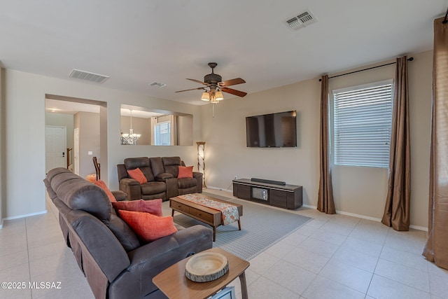 10487 S Cutting Horse Dr, Vail, AZ 85641 - living room with light tile patterned flooring, a ceiling fan, a chandelier, and baseboards