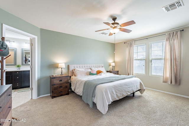 10487 S Cutting Horse Dr, Vail, AZ 85641 - bedroom with light colored carpet, baseboards, connected bathroom, and ceiling fan