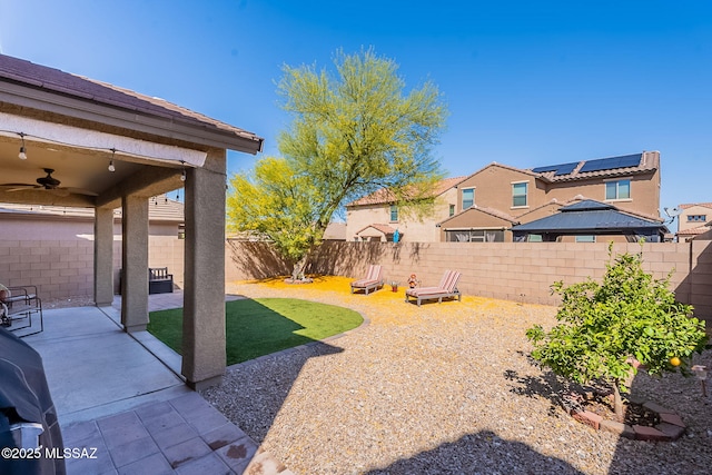 10487 S Cutting Horse Dr, Vail, AZ 85641 - fenced backyard with ceiling fan and a patio area