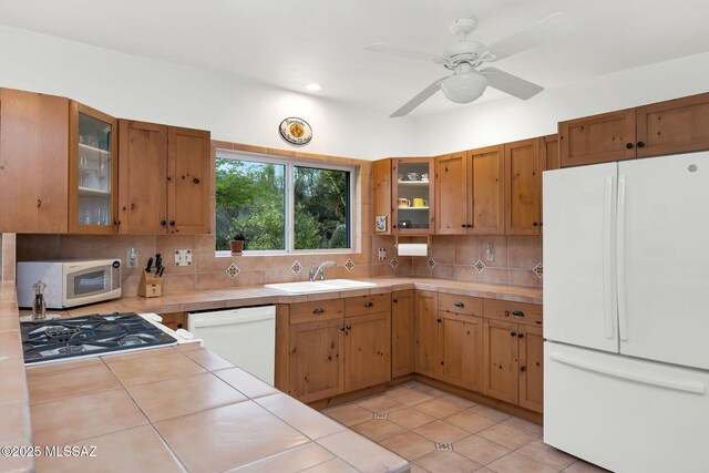 4921 E Camino De Los Olivos, Tucson, AZ 85718 - kitchen featuring white appliances, tile countertops, a sink, backsplash, and recessed lighting