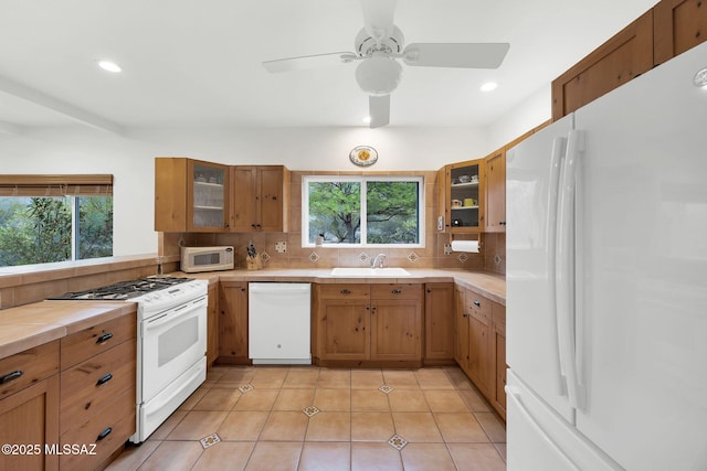 4921 E Camino De Los Olivos, Tucson, AZ 85718 - kitchen with white appliances, backsplash, light countertops, a sink, and recessed lighting