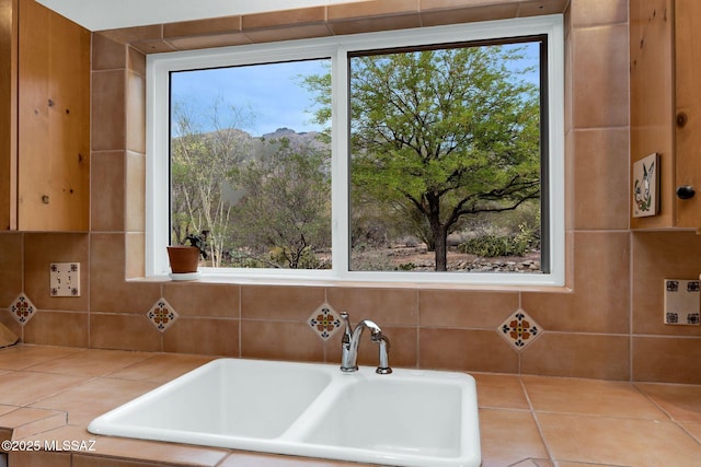 4921 E Camino De Los Olivos, Tucson, AZ 85718 - kitchen view of tile countertops, a sink, and decorative backsplash