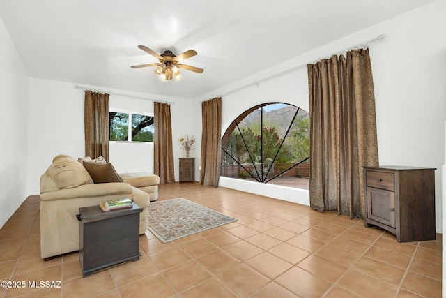 4921 E Camino De Los Olivos, Tucson, AZ 85718 - living room featuring light tile patterned floors and a ceiling fan