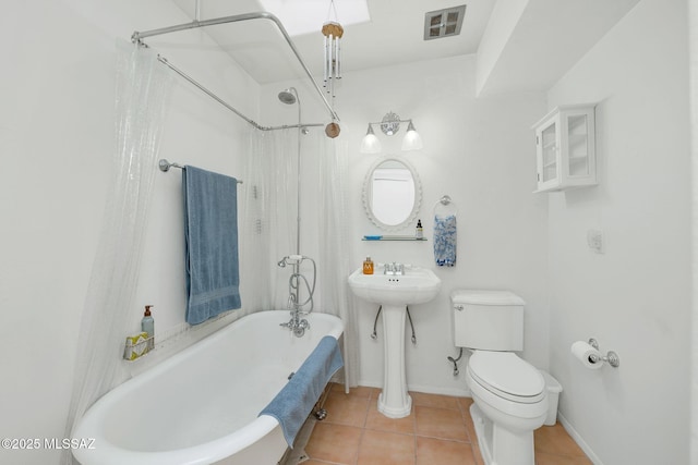 4921 E Camino De Los Olivos, Tucson, AZ 85718 - full bathroom with a freestanding tub, toilet, tile patterned floors, baseboards, and a shower with shower curtain