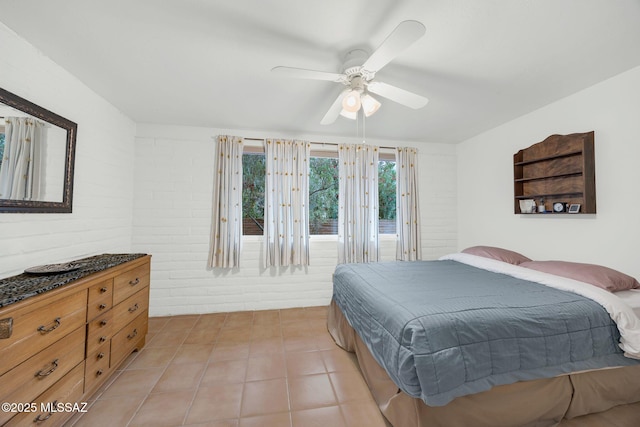 4921 E Camino De Los Olivos, Tucson, AZ 85718 - bedroom featuring brick wall, light tile patterned floors, and ceiling fan