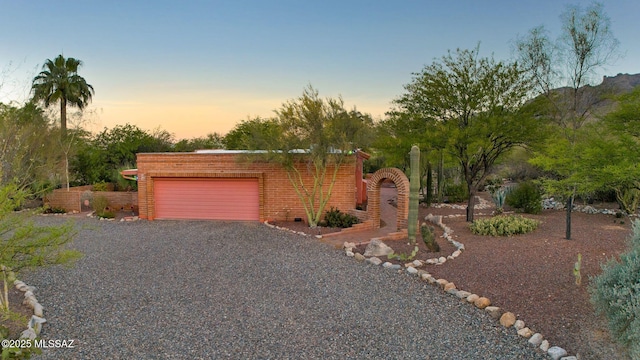 4921 E Camino De Los Olivos, Tucson, AZ 85718 - view of front of property with an attached garage, driveway, and brick siding