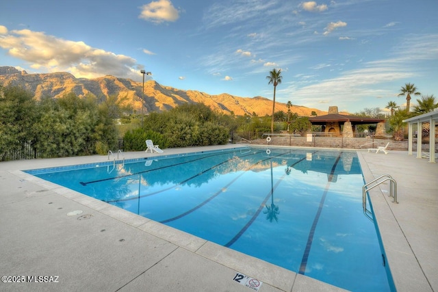 4921 E Camino De Los Olivos, Tucson, AZ 85718 - community pool with a mountain view, a gazebo, a patio, and fence