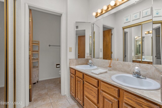 9350 E Speedway Blvd Unit 6, Tucson, AZ 85710 - full bath featuring double vanity, toilet, tile patterned floors, and baseboards