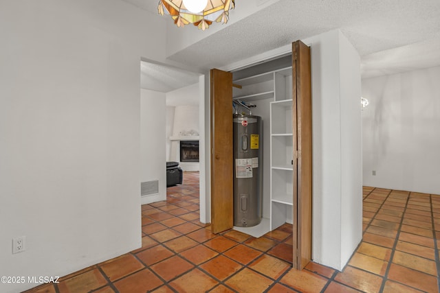 9350 E Speedway Blvd Unit 6, Tucson, AZ 85710 - hallway featuring water heater, a textured ceiling, and tile patterned floors