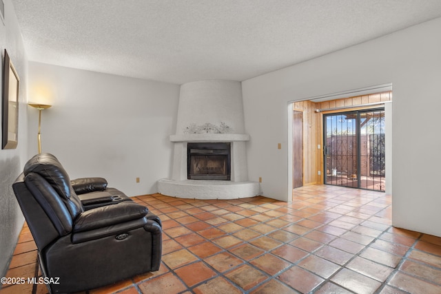 9350 E Speedway Blvd Unit 6, Tucson, AZ 85710 - unfurnished living room with a textured ceiling and a large fireplace