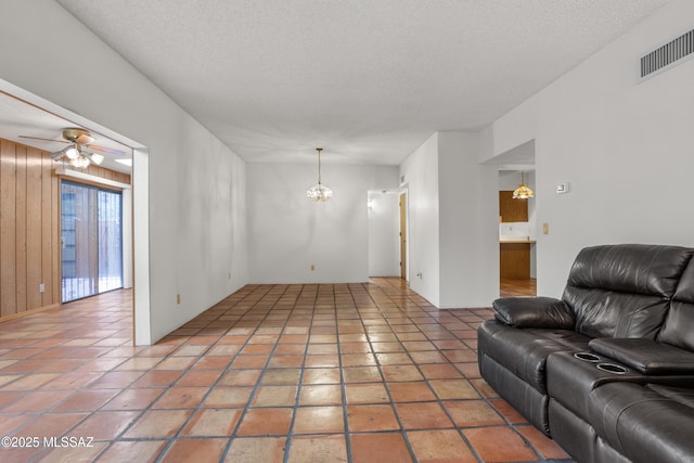 9350 E Speedway Blvd Unit 6, Tucson, AZ 85710 - living room featuring a ceiling fan, a chandelier, and a textured ceiling
