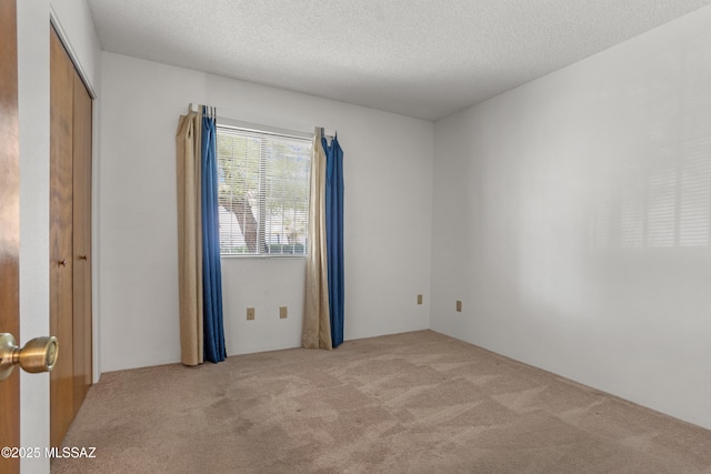 9350 E Speedway Blvd Unit 6, Tucson, AZ 85710 - carpeted spare room with a textured ceiling