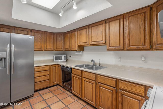 9350 E Speedway Blvd Unit 6, Tucson, AZ 85710 - kitchen featuring stainless steel fridge, black dishwasher, a sink, brown cabinets, and light countertops