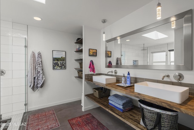 full bath with tiled shower, a skylight, baseboards, and recessed lighting
