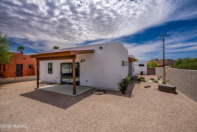 back of house with a patio area, stucco siding, and a fenced backyard