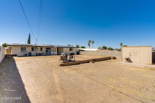615 W 6th Ave, San Manuel, AZ 85631 - rear view of house featuring a fenced backyard, roof mounted solar panels, and a patio area