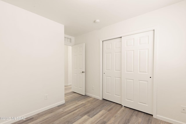 12356 N Globe Mallow Pl, Marana, AZ 85658 - unfurnished bedroom featuring wood finished floors and a closet