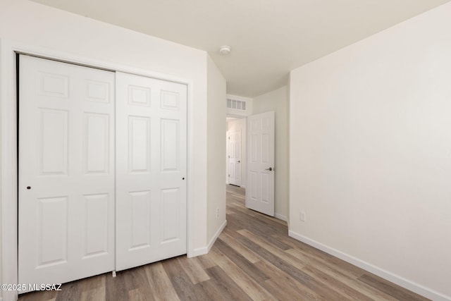 12356 N Globe Mallow Pl, Marana, AZ 85658 - unfurnished bedroom featuring wood finished floors and a closet