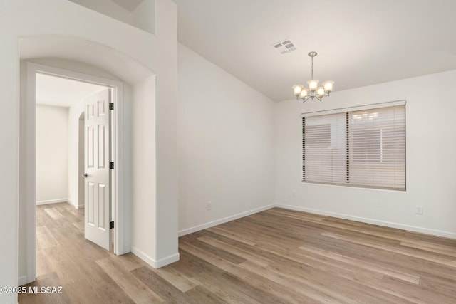 12356 N Globe Mallow Pl, Marana, AZ 85658 - spare room with light wood-style floors, a chandelier, and lofted ceiling