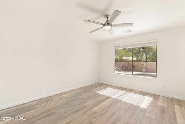 12356 N Globe Mallow Pl, Marana, AZ 85658 - empty room with light wood finished floors and ceiling fan