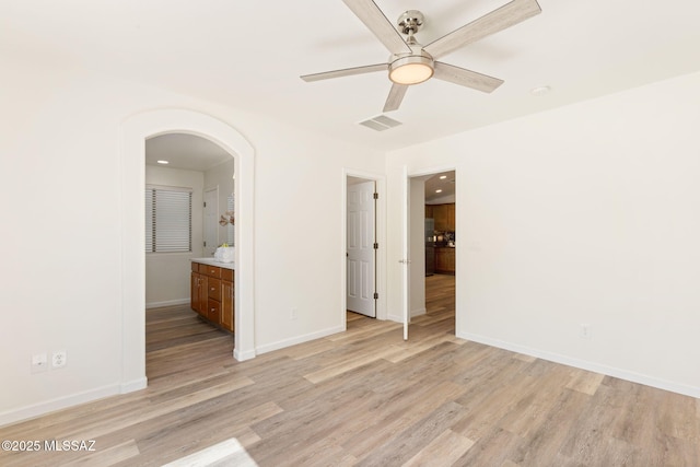 12356 N Globe Mallow Pl, Marana, AZ 85658 - unfurnished bedroom with light wood-style flooring, arched walkways, ensuite bathroom, a ceiling fan, and recessed lighting