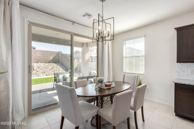6633 E Paseo De Sambuca, Tucson, AZ 85756 - dining space featuring a chandelier, light tile patterned floors, and baseboards