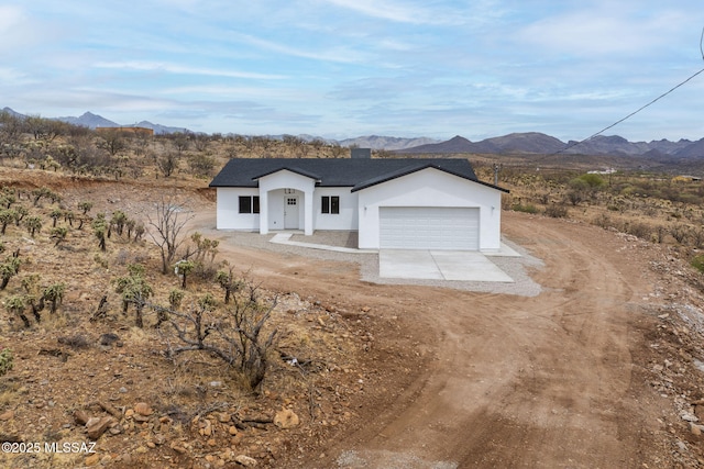 1895 Roma Ct, Rio Rico, AZ 85648 - modern farmhouse style home featuring stucco siding, a mountain view, a garage, and driveway