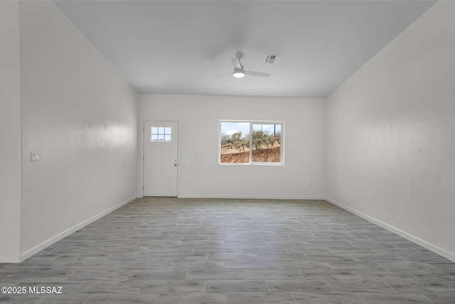 1895 Roma Ct, Rio Rico, AZ 85648 - unfurnished room with ceiling fan, wood finished floors, and baseboards