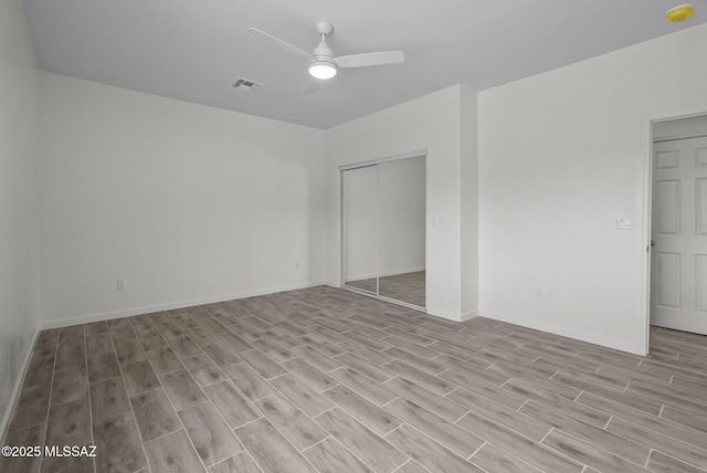 1895 Roma Ct, Rio Rico, AZ 85648 - unfurnished bedroom featuring light wood-style floors, a closet, baseboards, and a ceiling fan