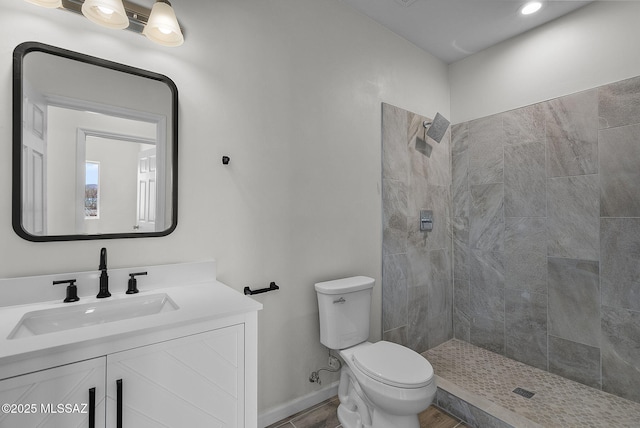 1895 Roma Ct, Rio Rico, AZ 85648 - bathroom featuring toilet, tiled shower, vanity, and baseboards