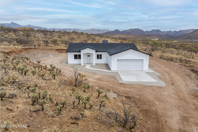 1895 Roma Ct, Rio Rico, AZ 85648 - modern inspired farmhouse with stucco siding, an attached garage, concrete driveway, a mountain view, and a shingled roof