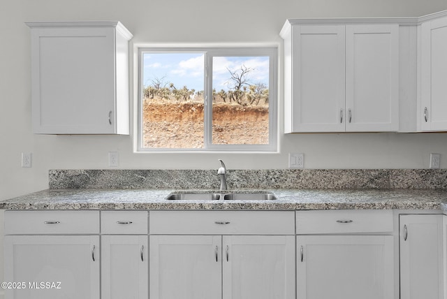 1895 Roma Ct, Rio Rico, AZ 85648 - kitchen featuring a sink, white cabinetry, and light stone countertops